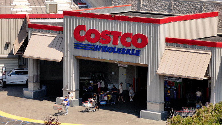 Costco entrance on sunny day with customers and carts