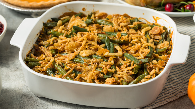 green bean casserole with fried onions in white dish