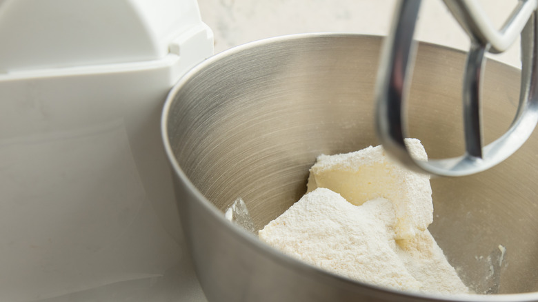 Cream cheese in a metal bowl, about to be whisked