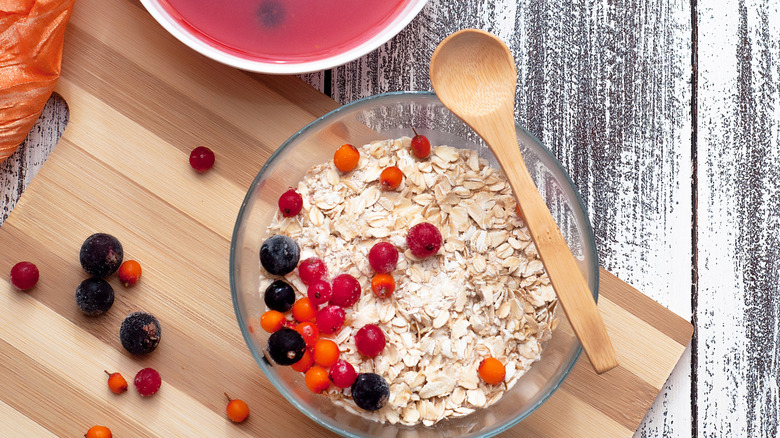 Dry oatmeal in bowl with fresh berries