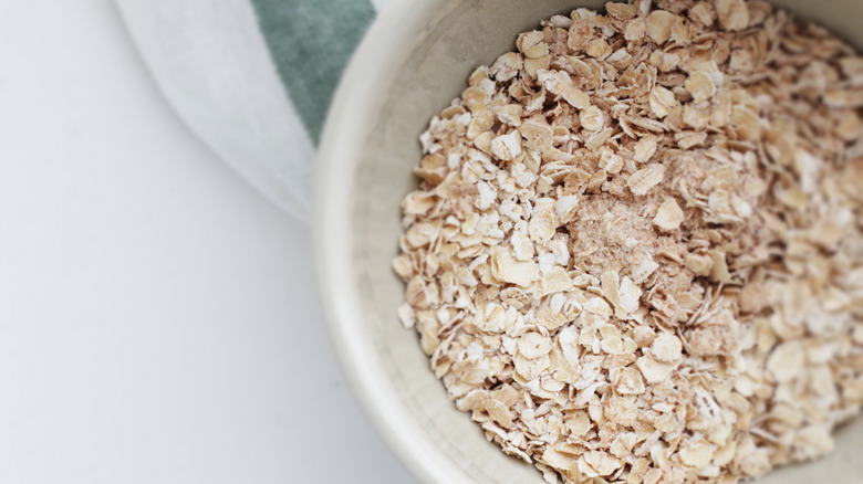 Dry instant oatmeal in white bowl