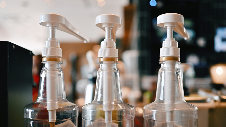 A stock photo of syrup pumps at a coffee shop.