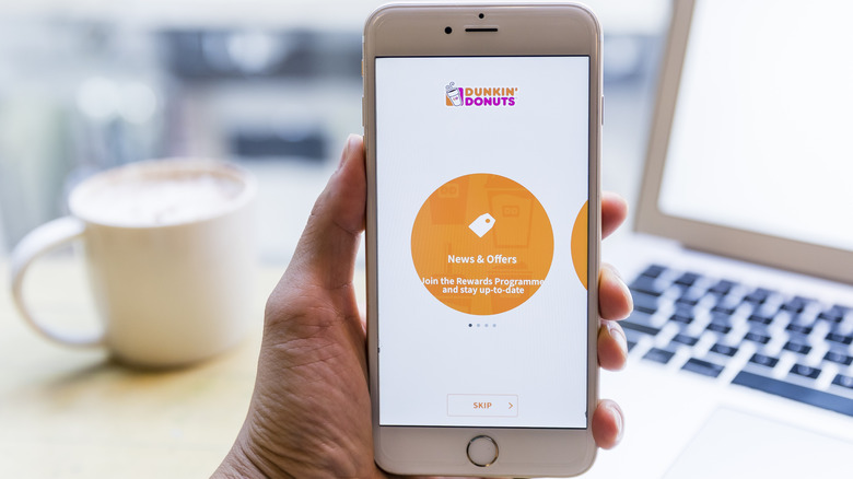 Stock photo of a phone with the Dunkin' Donuts app on it.