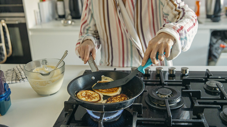 Woman cooking on gas stove