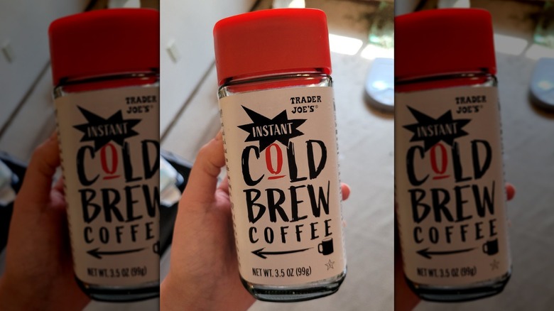 Hand holding jar of Instant Cold Brew Coffee