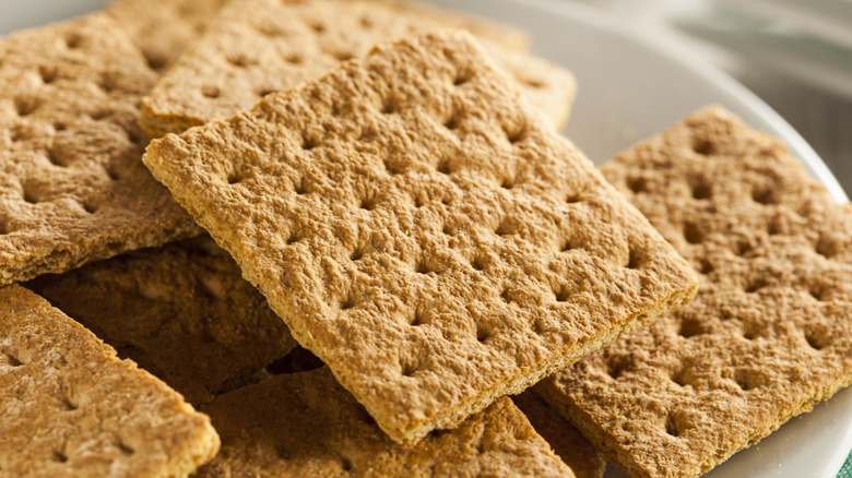 Plate of square-shaped graham crackers on stacked on top of one another