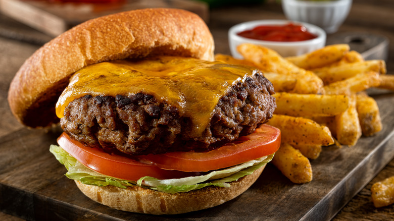 A burger with seasoned fries