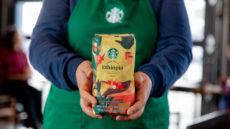 hands holding coffee bean package