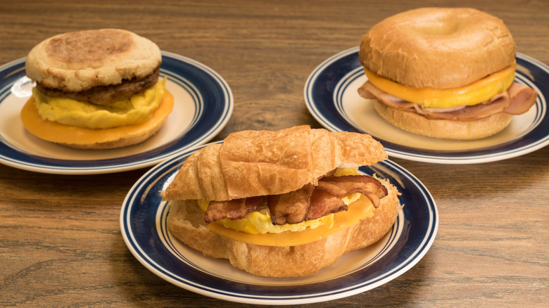 Various breakfast sandwiches on plates