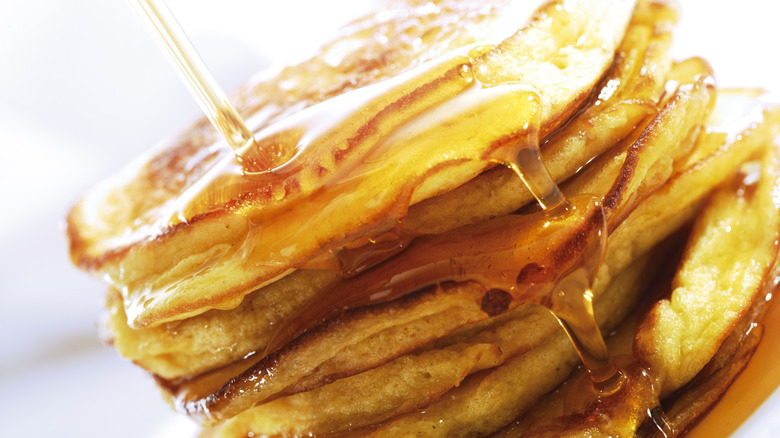 Maple syrup dripping off pancakes.