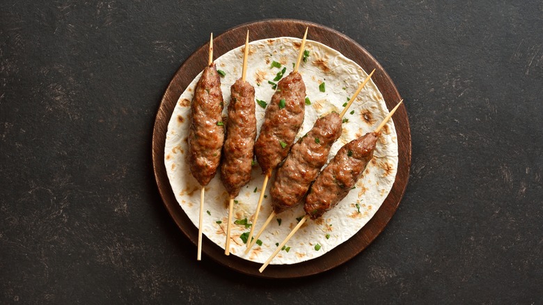 skewered kebabs on flatbread