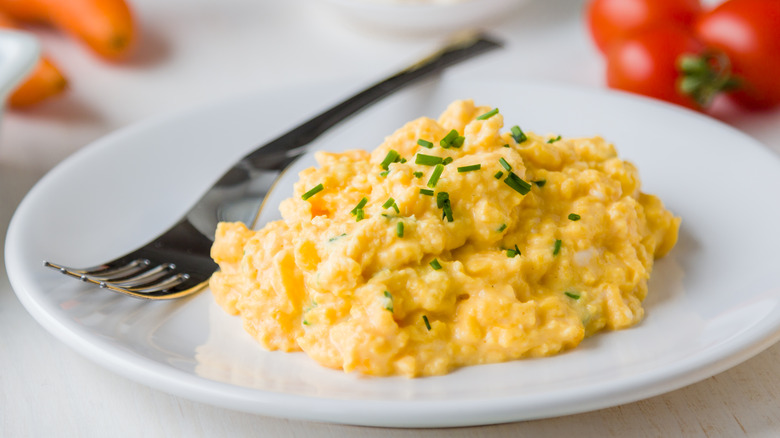 scrambled eggs on a plate with fork