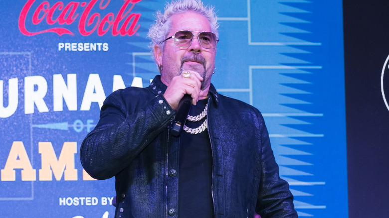 Guy Fieri in sunglasses with microphone