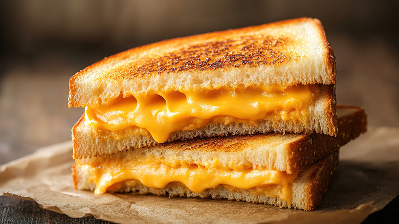 A melty and toasted grilled cheese sandwich cut in half