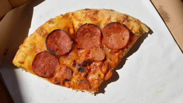 two slices of leftover pepperoni pizza in a box