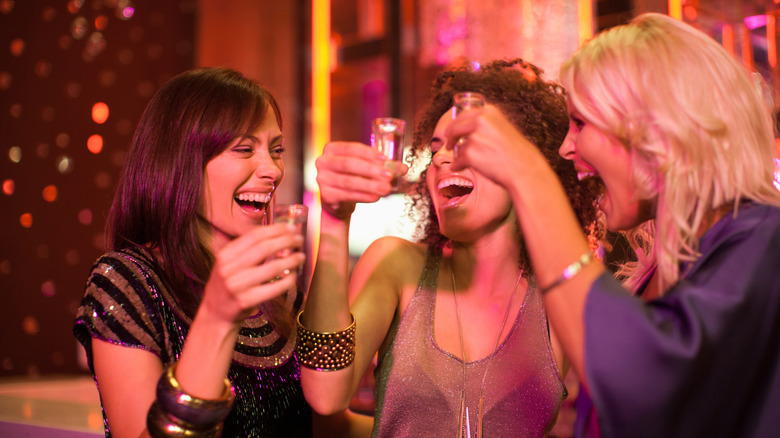 Three women with shot glasses