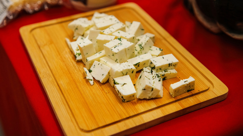 cheese sitting on a cutting board