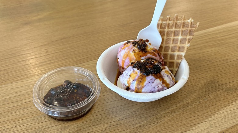 Two scoops of ice cream with a side of chili crisp