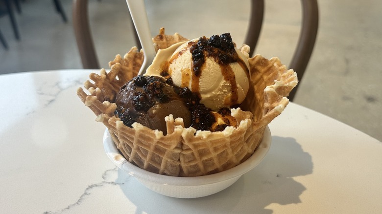 Three scoops of ice cream topped with chili crisp
