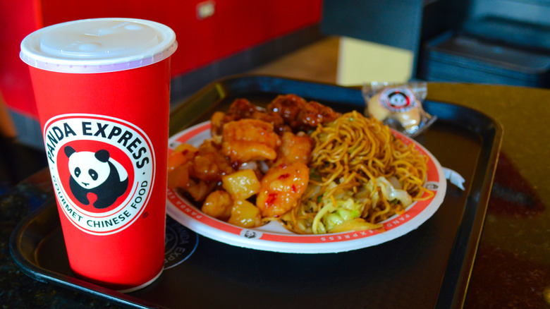 A Panda Express meal on a tray with a drink