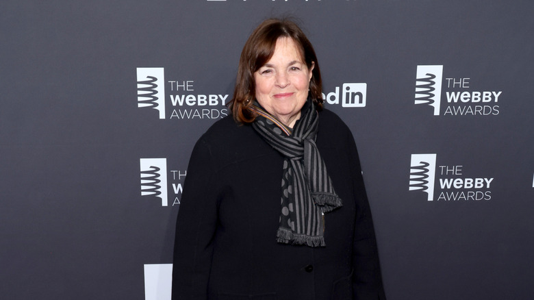 Ina Garten poses before a gray backdrop