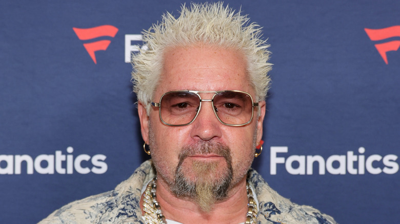 Close up of Guy Fieri with sunglasses on smiling