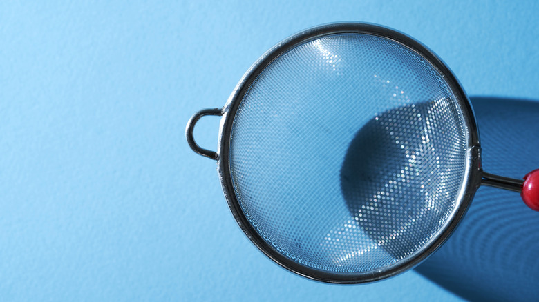 fine mesh sieve against a blue background