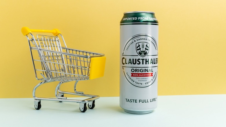 Clausthaler can and shopping cart on yellow background