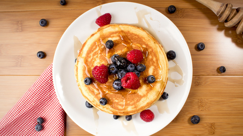 Pancakes with fresh fruit and syrup on a plate