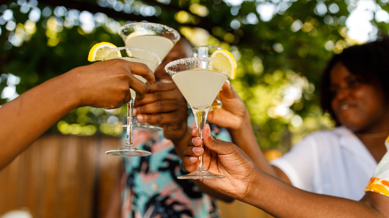 People toasting lemon cocktails