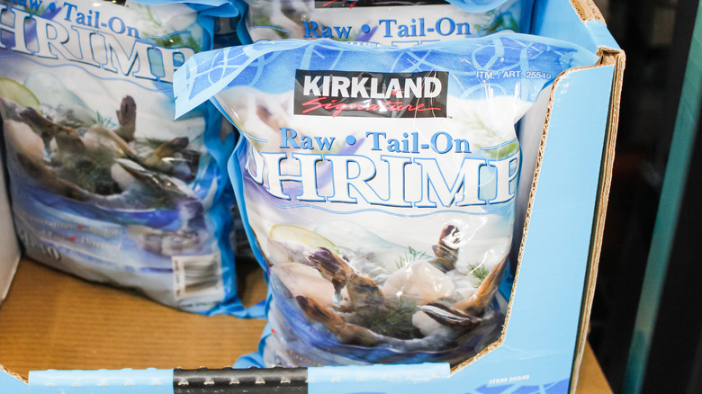 Bags of Kirkland Signature frozen shrimp on display at the store