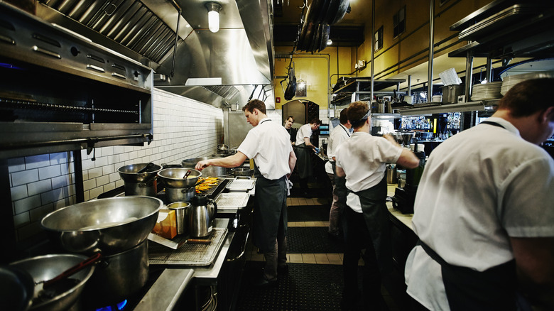 a commercial kitchen with cooks at work