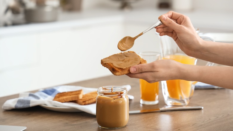 nut butter being spread on bread