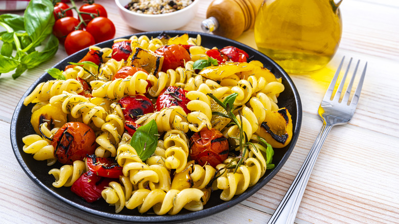 A bowl of pasta salad with vegetables