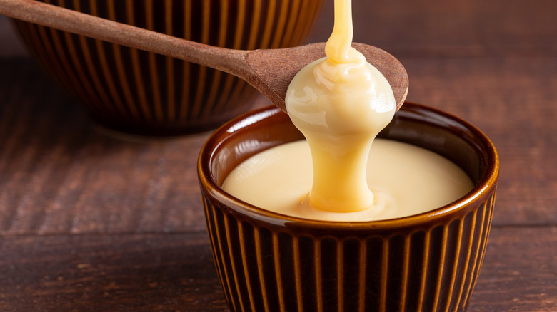 wooden spoon dripping condensed milk