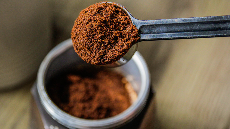 Close up shot of a spoon with coffee grounds