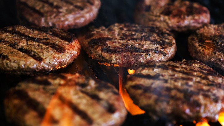 Multiple hamburger patties on a grill