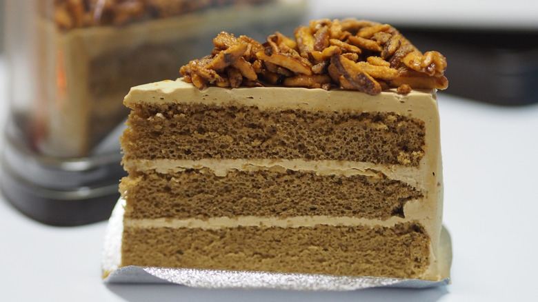 piece of cake with frosting and nuts