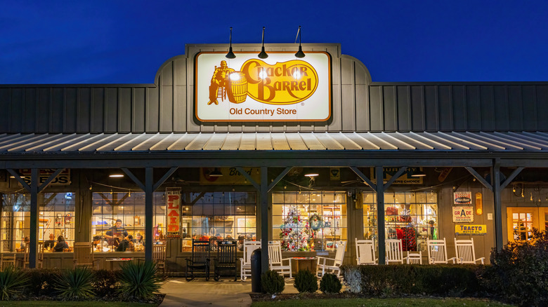 Cracker Barrel exterior with a porch full of rocking chairs.