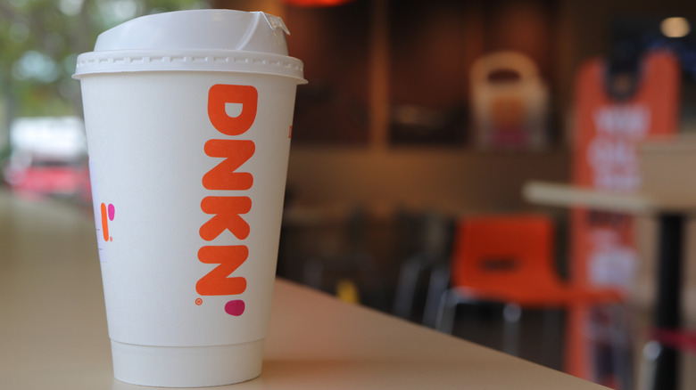 A white cup of hot Dunkin' coffee