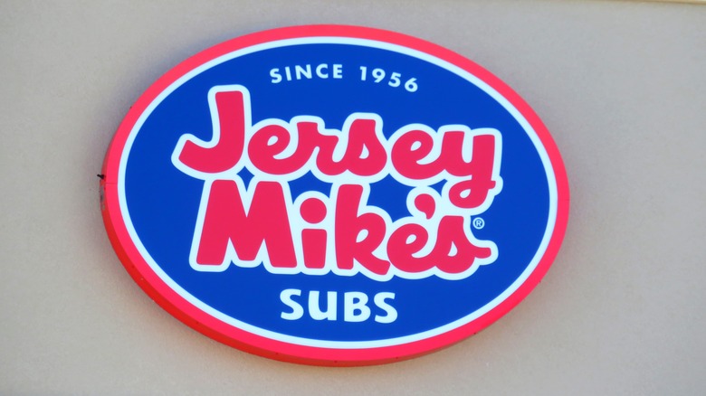 An old Jersey Mike's Subs sign on the outside of a building