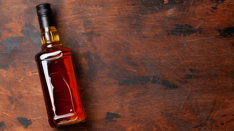 bottle of whiskey on a wood backdrop