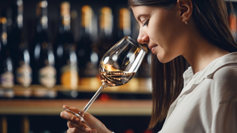 Female sommelier tasting wine