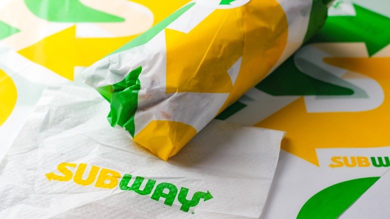 Wrapped Subway sandwiches on napkins