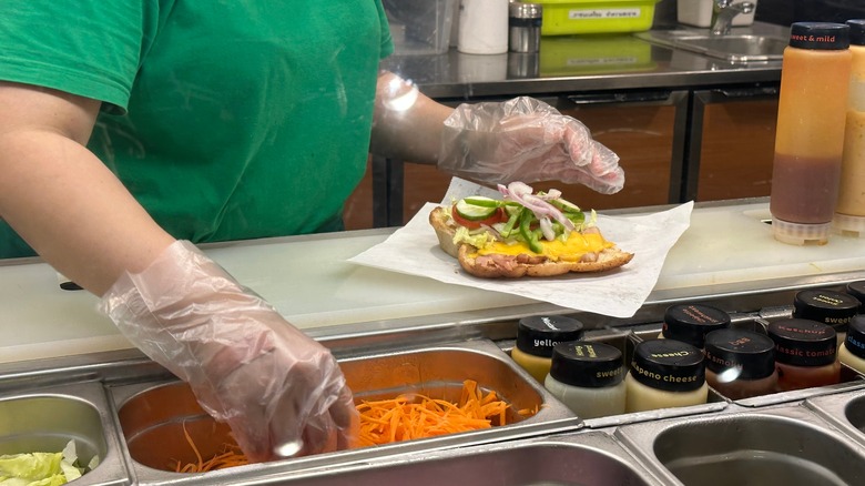 Subway worker building sandwich