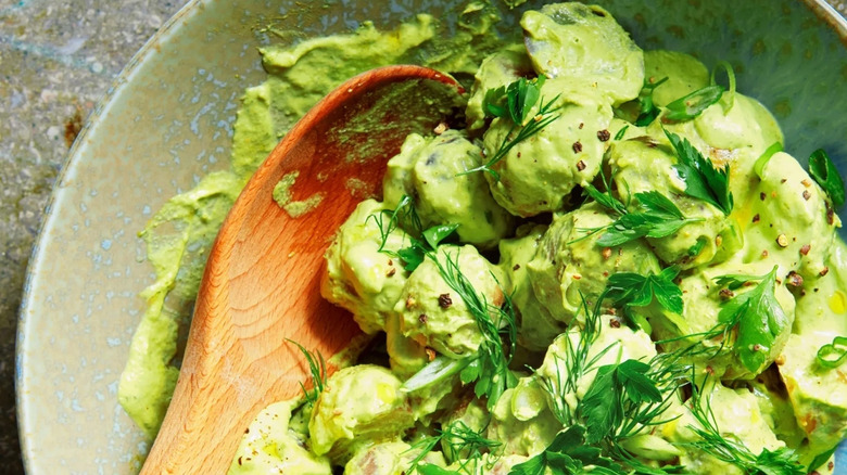 bowl of green goddess potato salad with fresh herbs