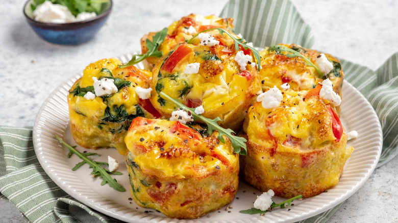 Egg muffins with red bell peppers, feta cheese, and arugula