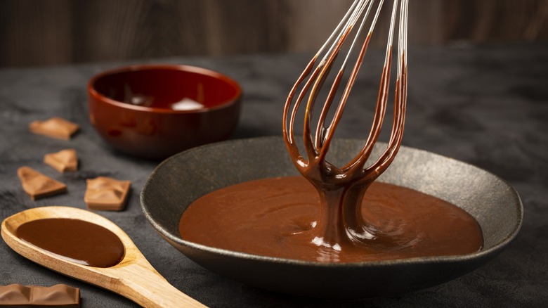 Chocolate ganche in a bowl being whisked