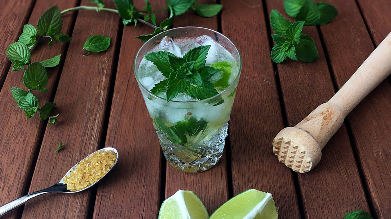 cocktail with muddled herbs and lime