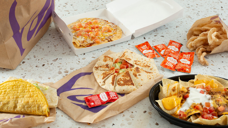 Multiple dishes and bags from Taco Bell